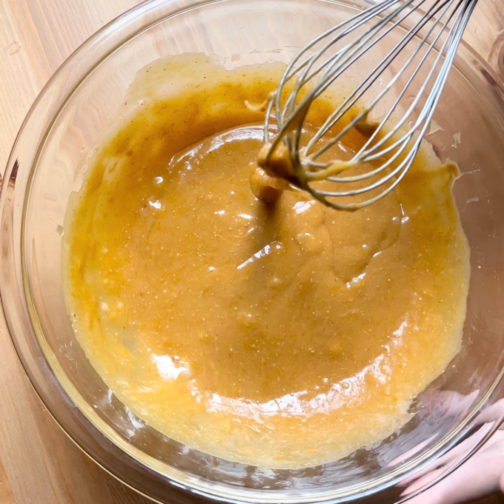 Wet ingredients for wake up muffins mixed in glass bowl
