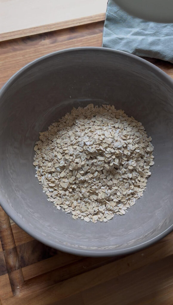 Gray bowl full of organic rolled oats