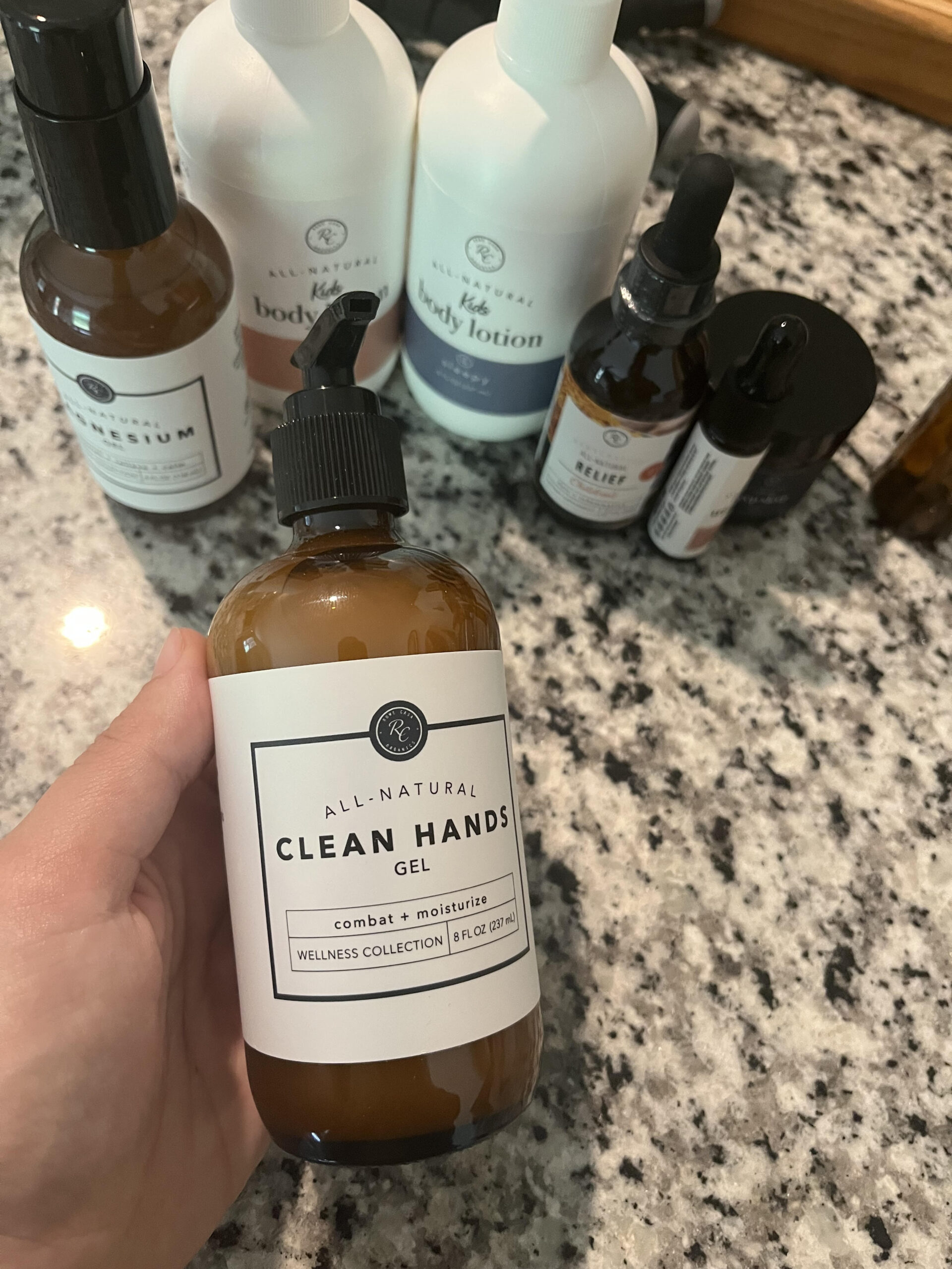 Non toxic hand cleaner on bathroom counter with other non toxic health products for diaper bag