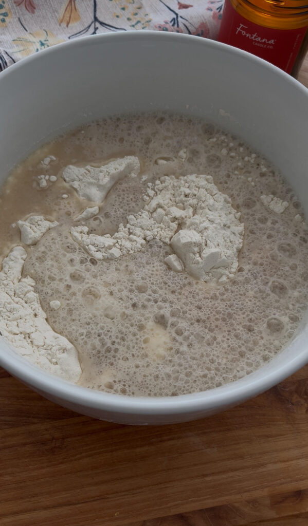 Yeast mixing into bowl of flour