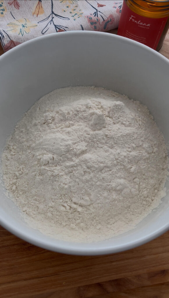 Sunrise flour mill flour sitting in white bowl on a wooden cutting board