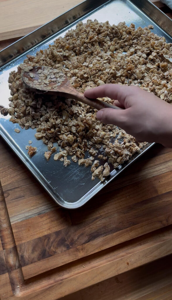 Homemade granola on stainless steel baking sheet.